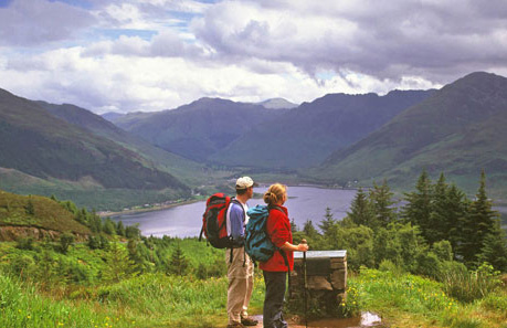 TWO WALKERS STAND AT A VIEWPOINT LOOKING OVER TO LOCH DUICH AND THE FIVE SISTERS OF KINTAIL FROM MAM RATAGAN (RATAGAIN)- A MOUNTAIN PASS LEADING FROM THE FOOT OF GLEN SHIEL TO THE FOOT OF GLEN MORE, HIGHLAND. PIC: P.TOMKINS/VisitScotland/SCOTTISH VIEWPOINT Tel: +44 (0) 131 622 7174 Fax: +44 (0) 131 622 7175 E-Mail : info@scottishviewpoint.com This photograph can not be used without prior permission from Scottish Viewpoint.
